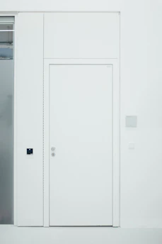 Modern white PVC door installed in a bright, contemporary home interior.