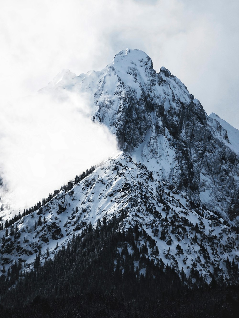 snowy mountain covered with clouds