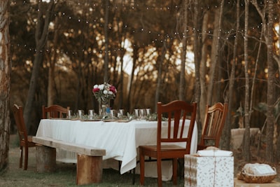 dining table and chairs set in the middle of the woods feast google meet background