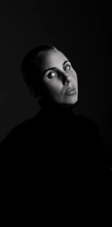 Artistic black-and-white portrait of kocksure with intense gaze, embodying resilience.
