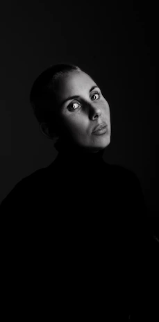 Artistic black-and-white portrait of kocksure with intense gaze, embodying resilience.