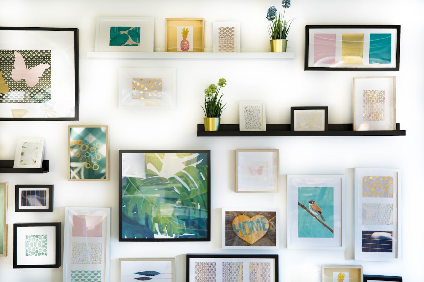 Framed art prints displayed on a gallery wall