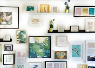 assorted-color framed paintings on the wall