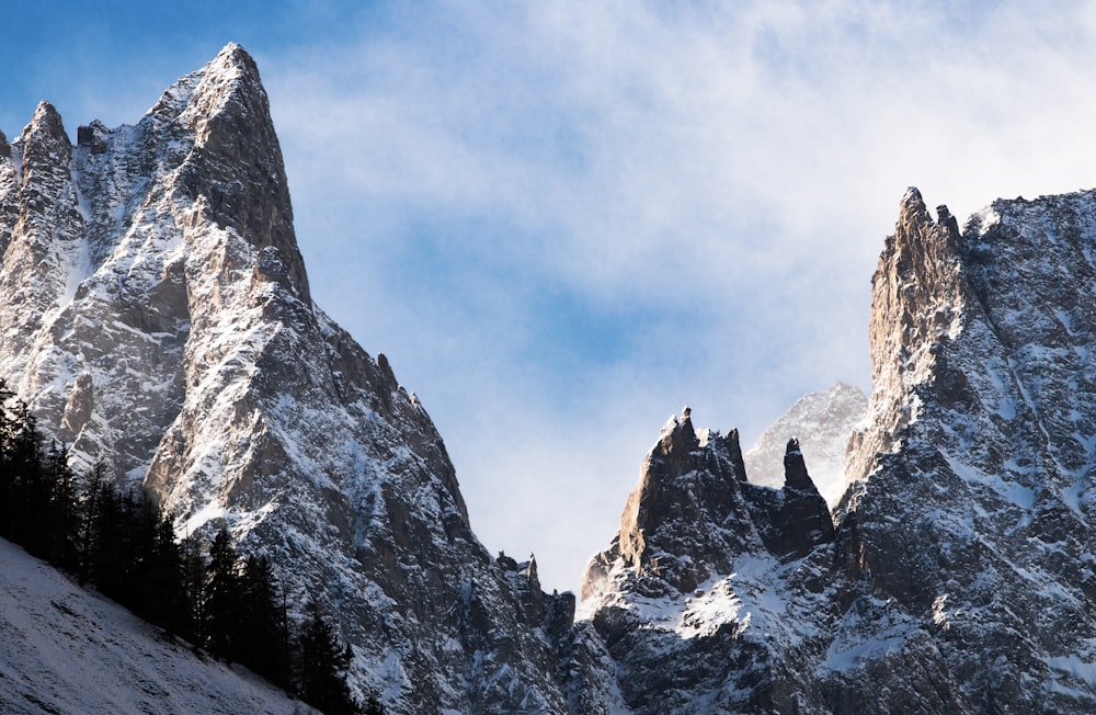 mountain covered with snows under white cloudy sky