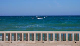 Crystal clear blue sea seen from the Spiaggia di Serapo, framed by sandy shore.