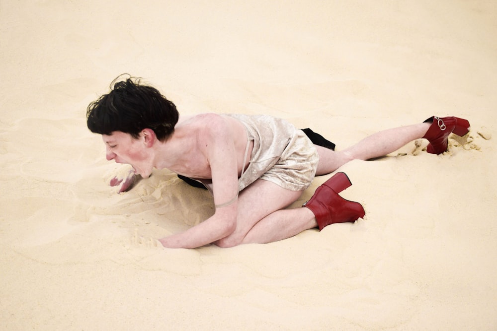 person crawling on sand