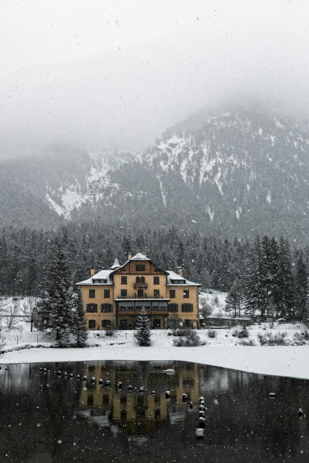 house near mountain covered snow