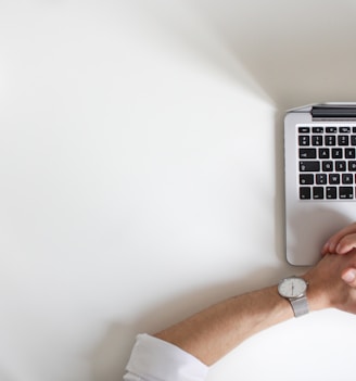 person wearing watch near laptop