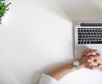 person wearing watch near laptop