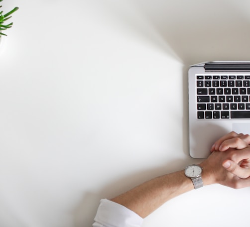 person wearing watch near laptop