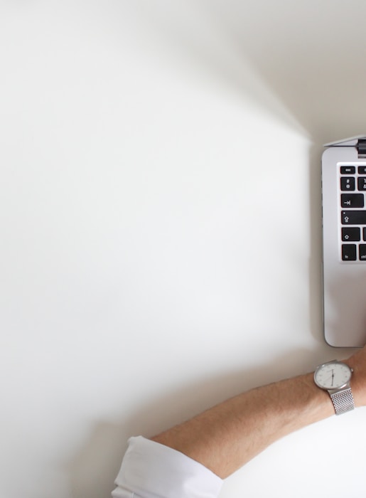 person wearing watch near laptop