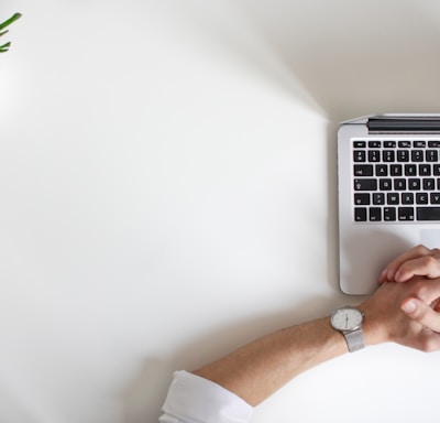 person wearing watch near laptop