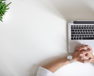 person wearing watch near laptop