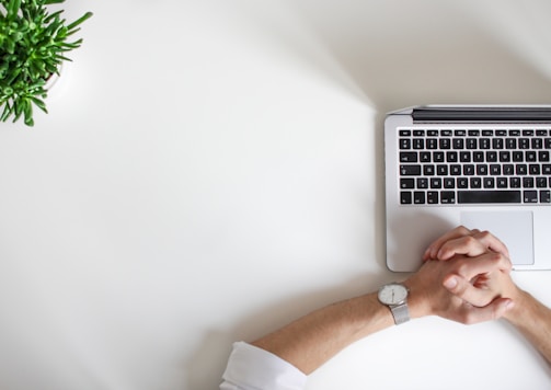 person wearing watch near laptop