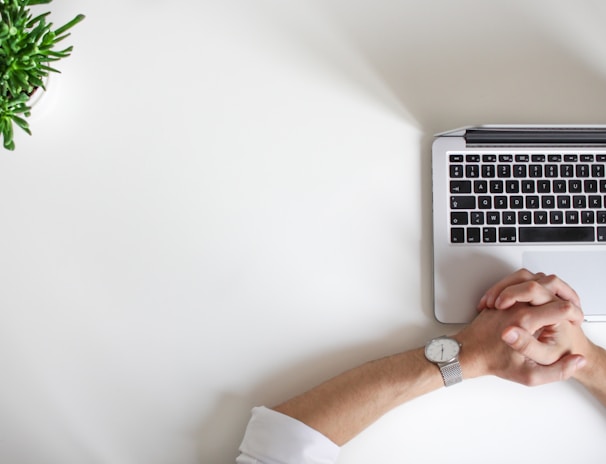 person wearing watch near laptop