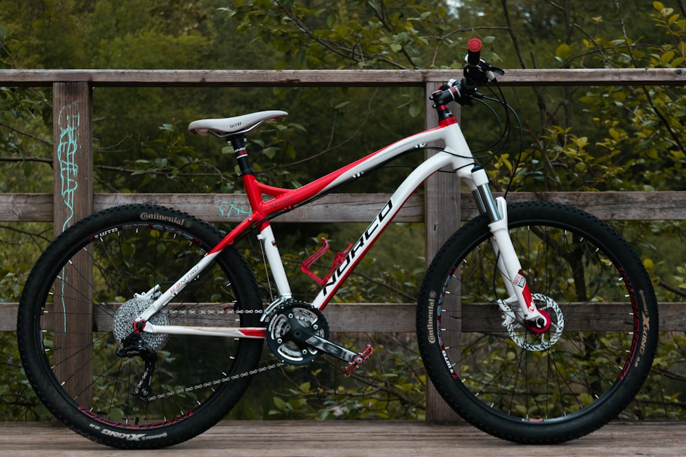 white and red hardtail bike parked on the bridge