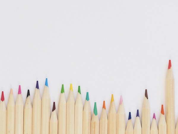 Colouring pencils arranged beside an open activity book