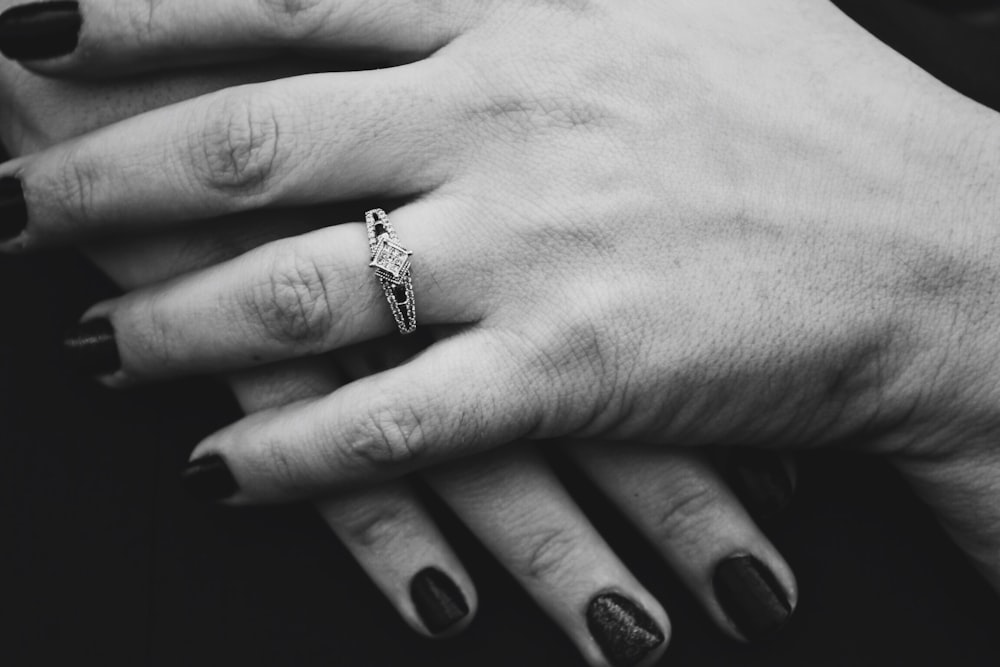 grayscale photography of person wearing ring