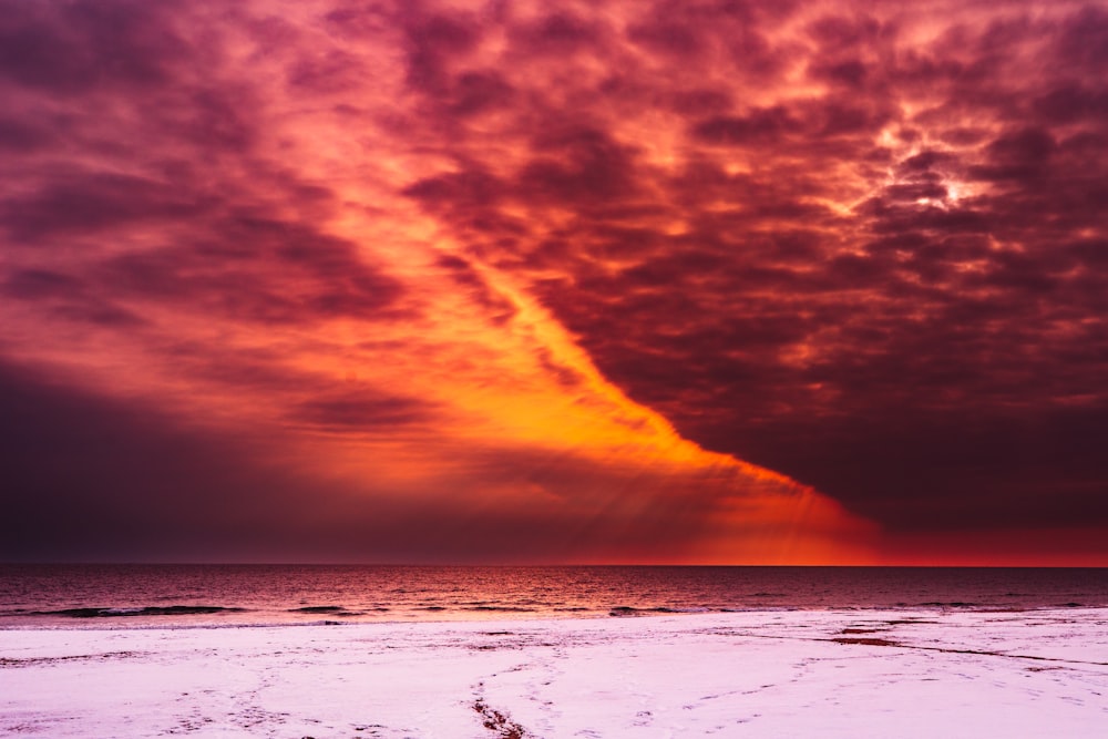 sea and red sky during daytime
