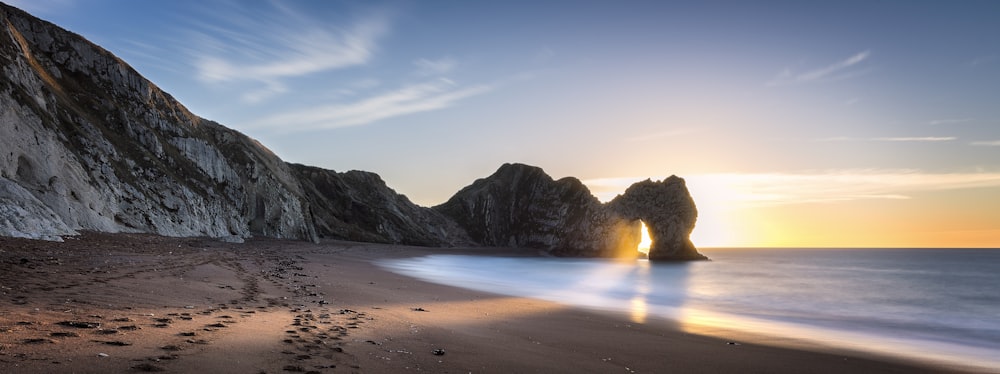 time lapse photography of rock formation on body of water