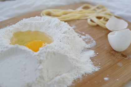 Flour and egg on a wooden counter for baking