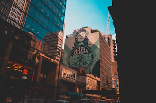 Obey billboard on brown building low-angle photography at daytime