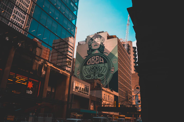 Obey billboard on brown building low-angle photography at daytime