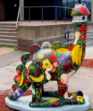 A cheerful child coloring a friendly T-Rex dinosaur outline with bright crayons.