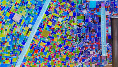 A close-up of a vibrant mosaic artwork showcasing intricate tile patterns.