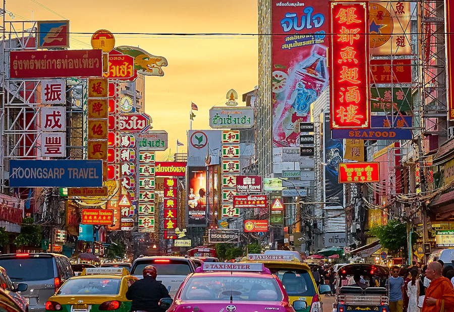 Neon signs above Yaowarat road in Bangkok's Chinatown at dusk