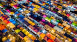Panoramic view of a bustling market with colorful stalls and shoppers