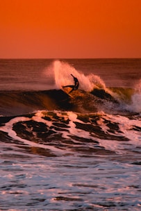 person surfing during sunset