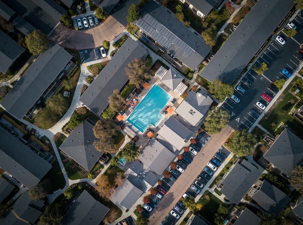 aerial view of blue pool near parking area at daytime