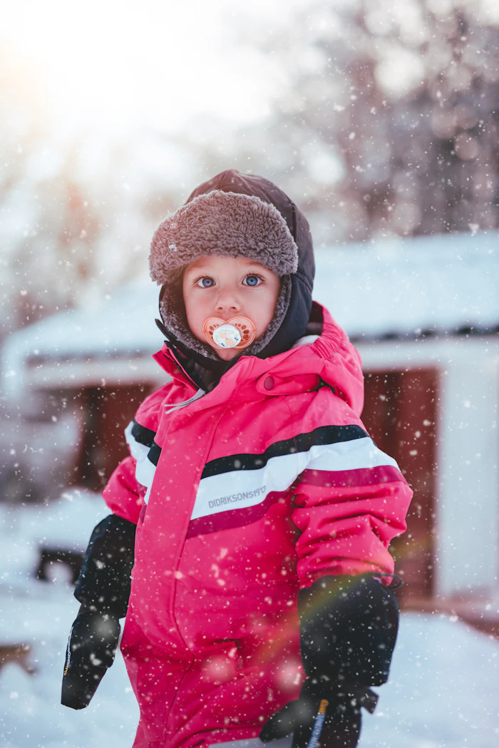 Boy wearing a pink jacket and beanie