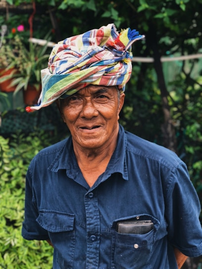 Portrait of Raj Kumar Boora standing in a lush green farmland near Bhiwani, smiling confidently.