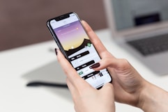 person hand holding iPhone X
