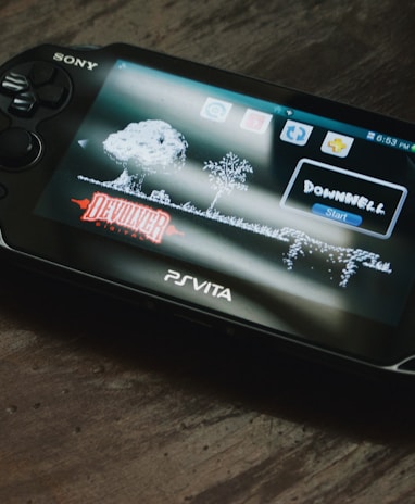 black Sony PS Vita on brown wooden surface