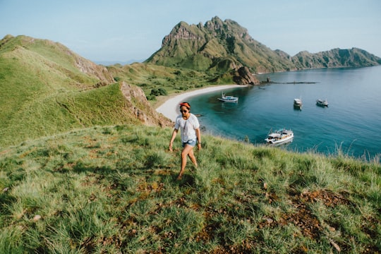person walking on green grass in Komodo National Park Indonesia
