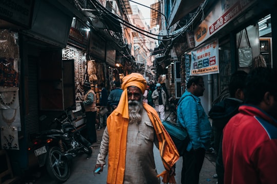 man in orange turban standing in middle of road in New Delhi India