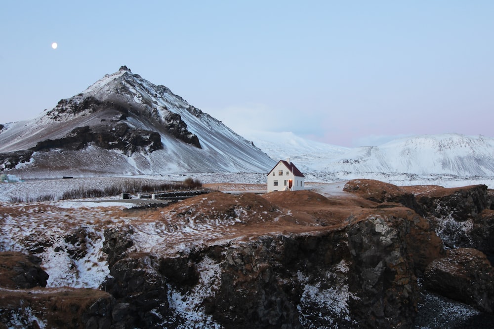 brown and white concrete house with distance to brown mountain