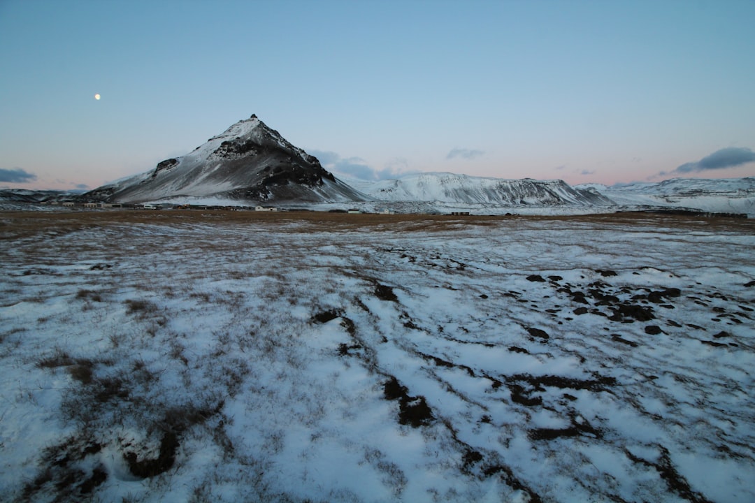 landscape photo of lake covered in snow near mountain during daytie