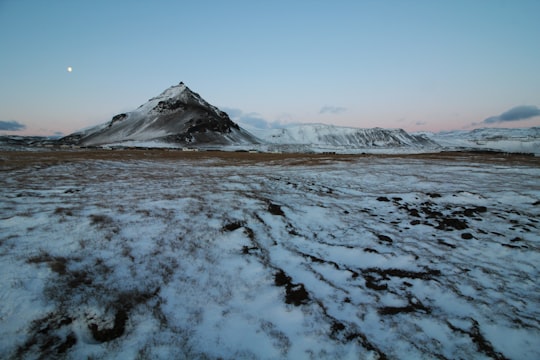 landscape photo of lake covered in snow near mountain during daytie in Arnarstapi Iceland