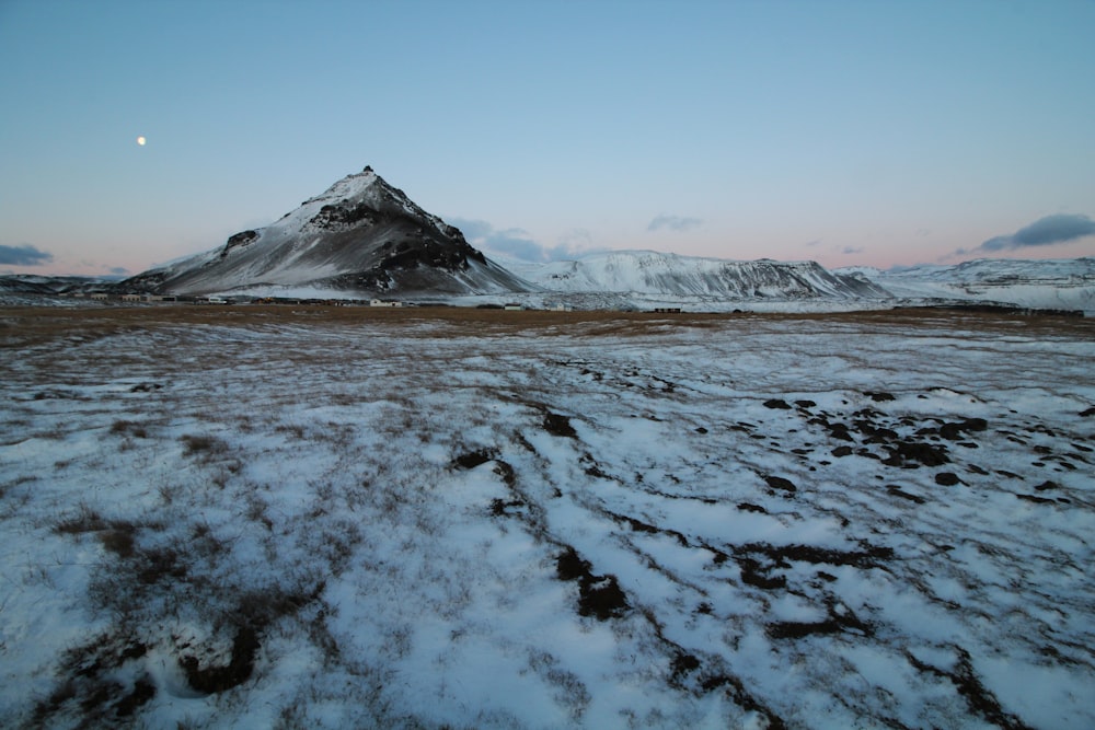 landscape photo of lake covered in snow near mountain during daytie