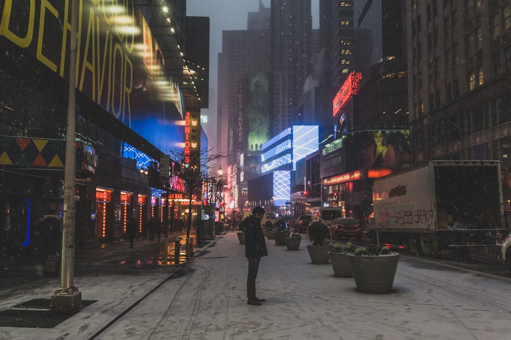 man standing near white pole