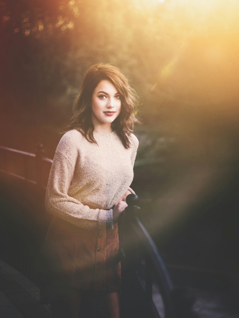 woman standing beside black railings during daytime