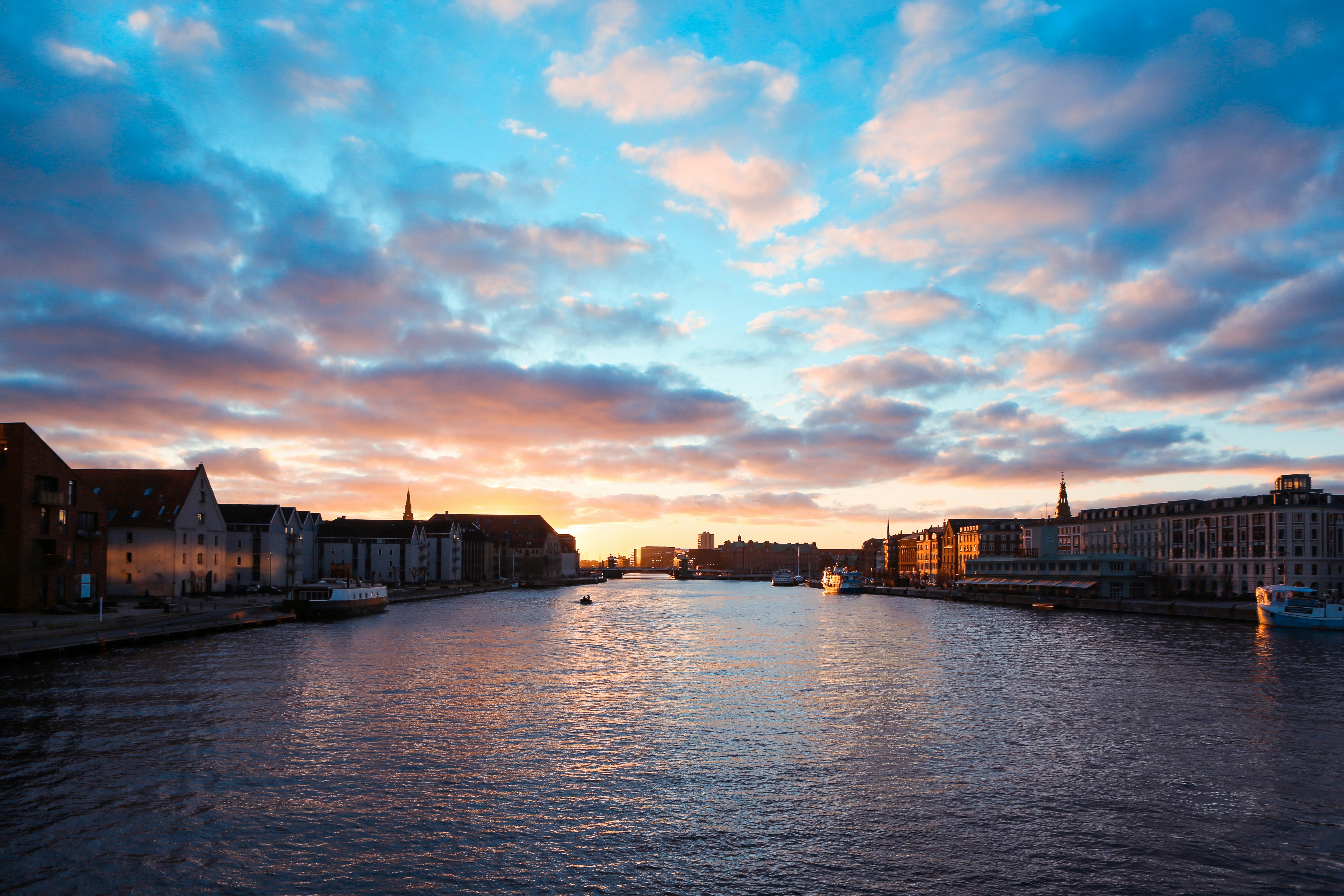 brown concrete building under white clouds during daytime, Copenhagen Winter Clouds at the Canal