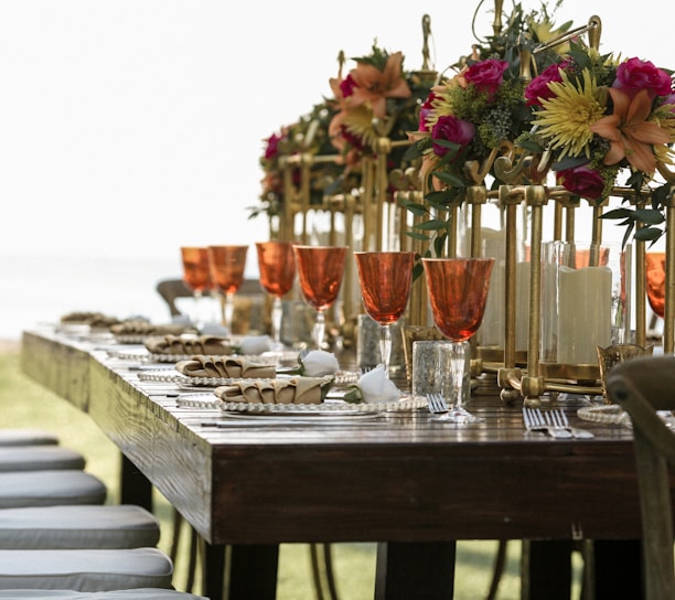 orange tinted wine glasses on rectangular brown wooden dining table