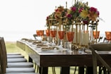 orange tinted wine glasses on rectangular brown wooden dining table