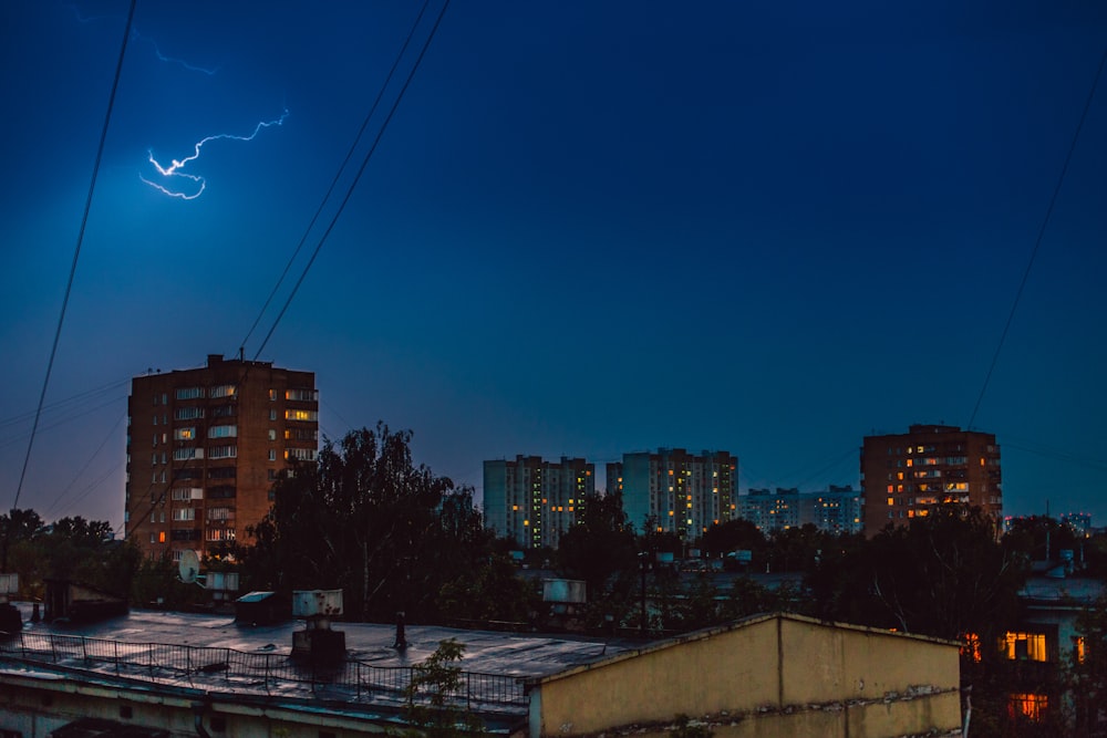 urban city under gray sky during nighttime