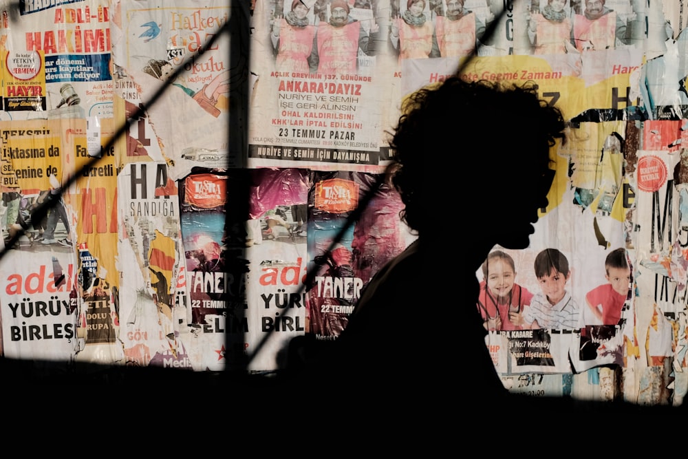 silhouette of person near magazine wall